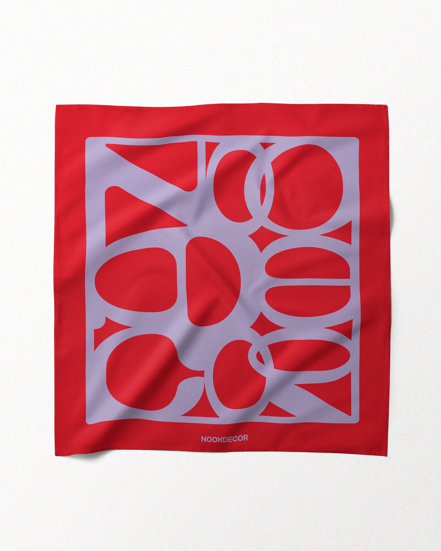 A dopamine red and purple 100% mulberry silk handkerchief bandana features NOOKDECOR’s brand logo, laid flat on a neutral beige background, showcasing its eclectic style for bold and maximalist fashion style.