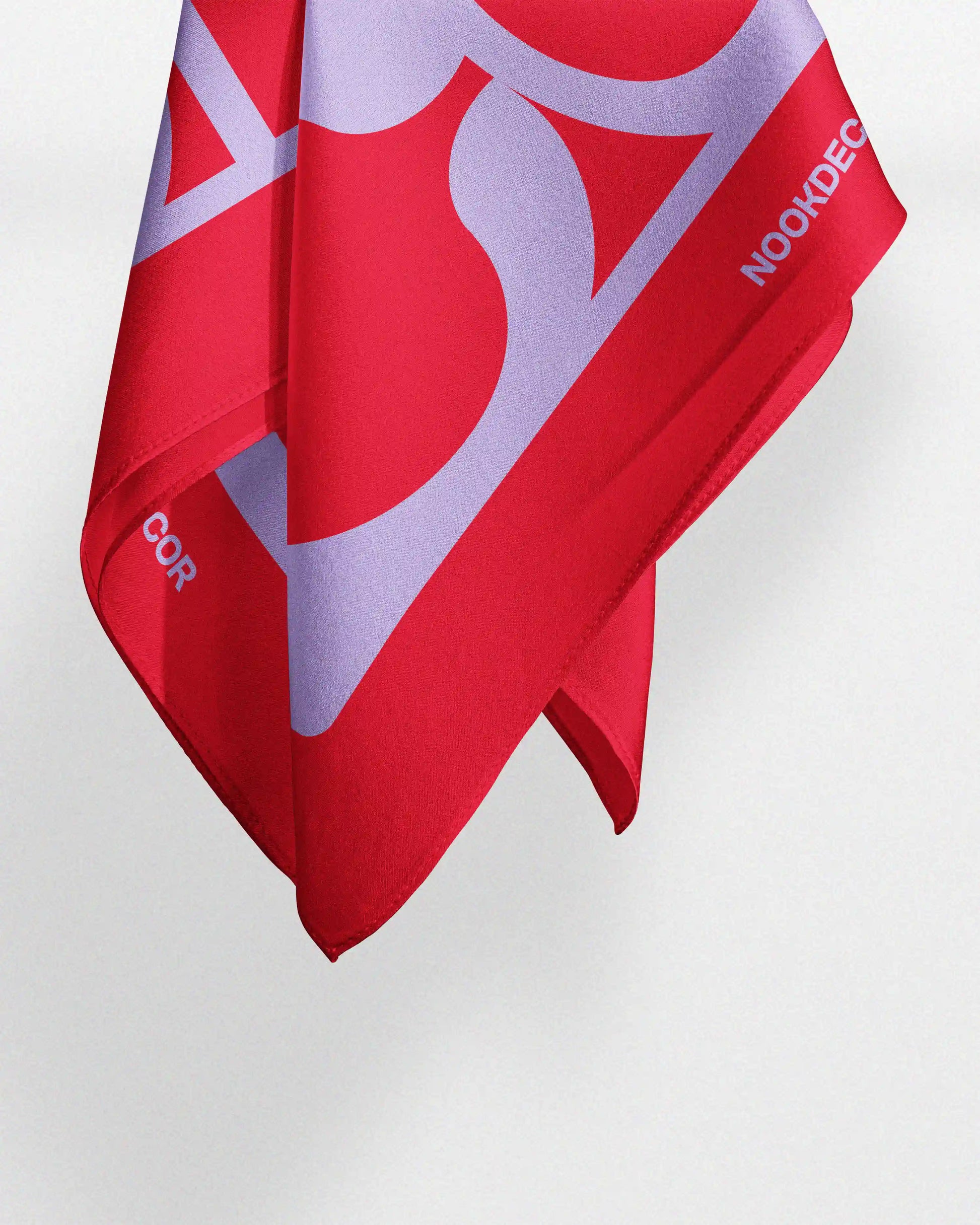 Dopamine red and pastel purple silk bandana hanging naturally to demonstrate its dynamic drape and incredible softness features of this multifunctional scarf that can also be used as a chic silk handkerchief, bandana, Tilly, or table placemat for special occasions.