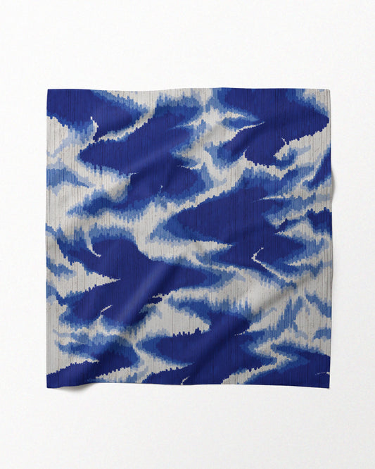 Flat lay of a vibrant dopamine dressing 100% mulberry silk scarf placed on a beige background for eclectic style dressing.