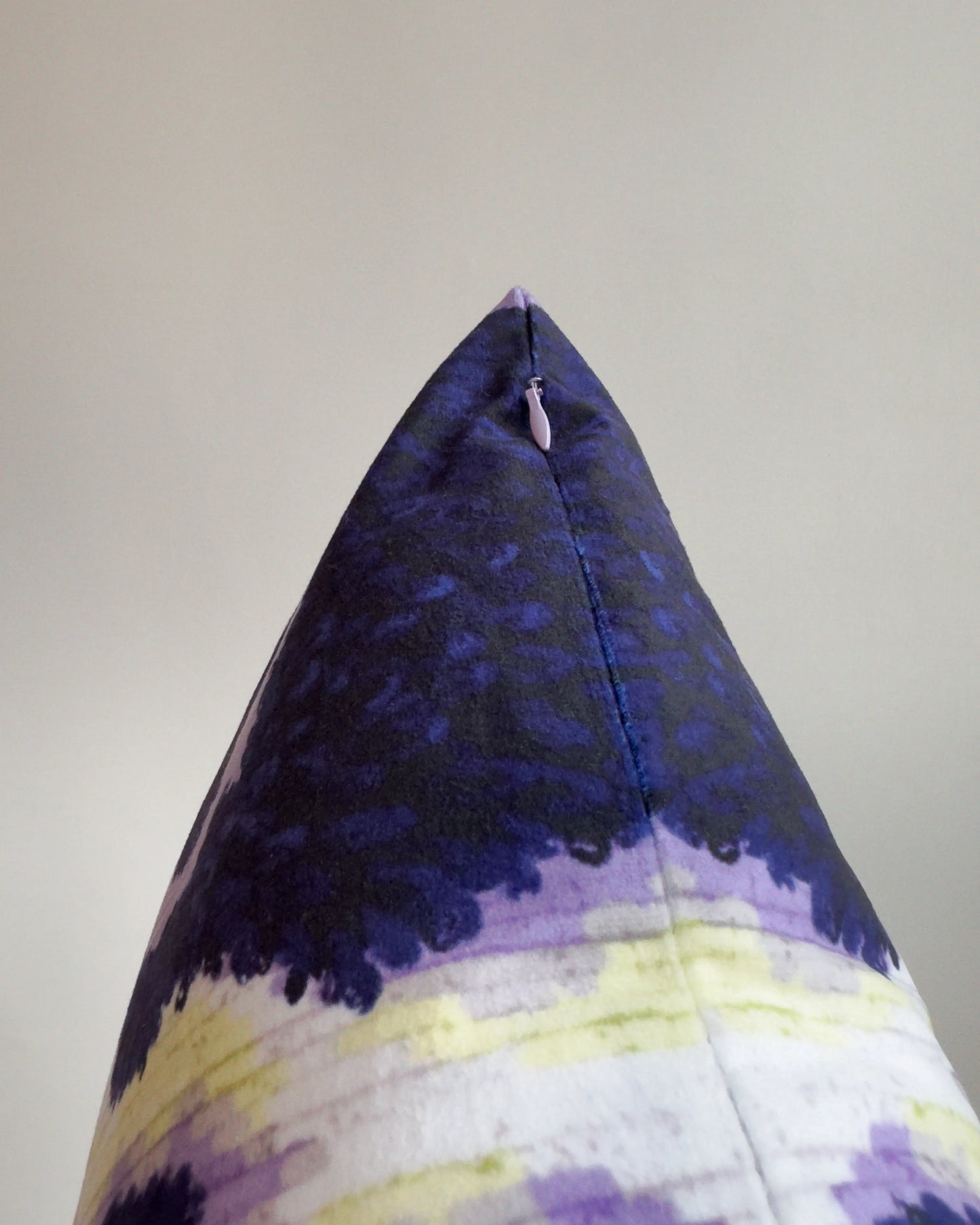 Close-up of hidden zipper closure in pastel purple on dark brown, pastel purple and off white abstract cowhide cushion cover, showing easy insertion and premium construction details.