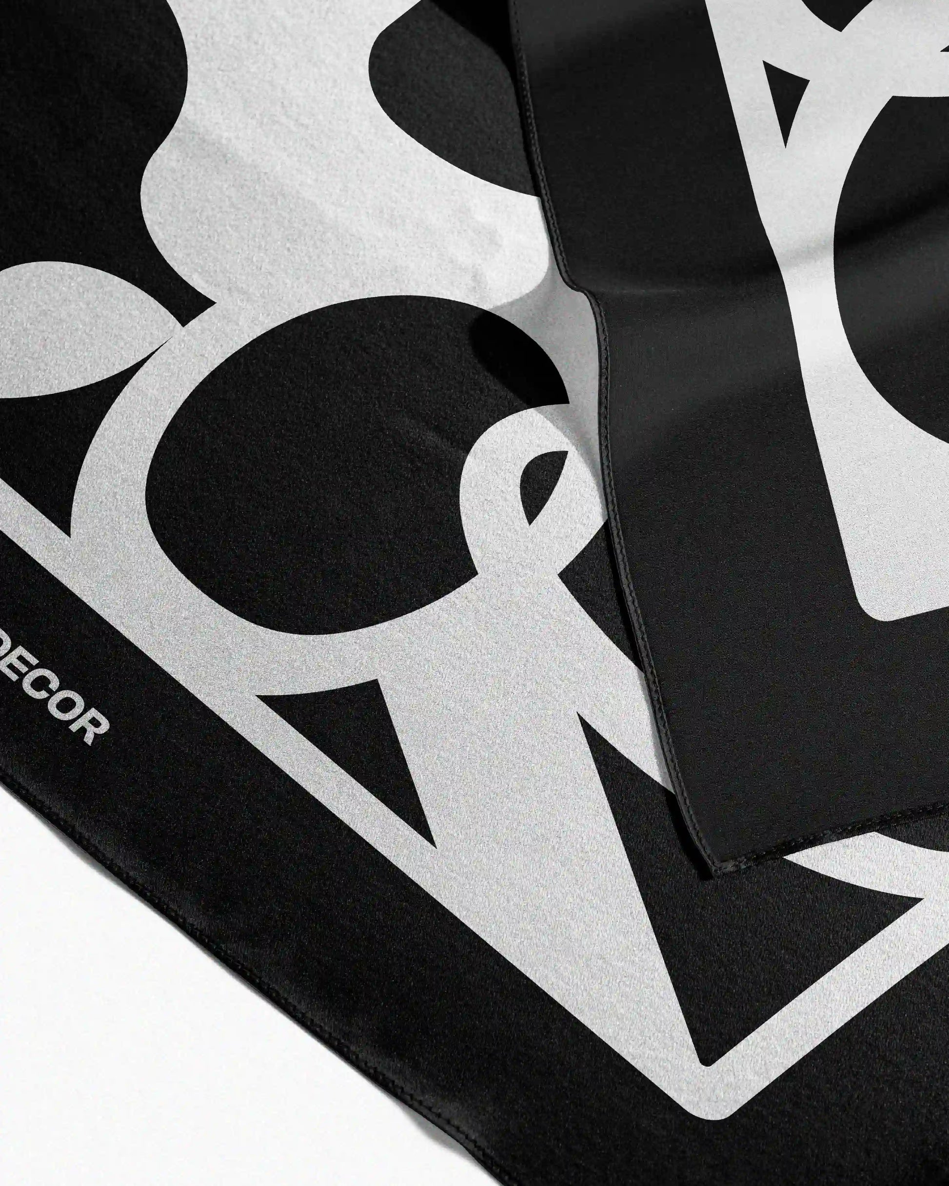 Neatly folded versatile 100% mulberry silk scarf, a 4-in-1 convertible accessory that can be a twilly, table placemat, waist scarf, or hair wrap bandana.