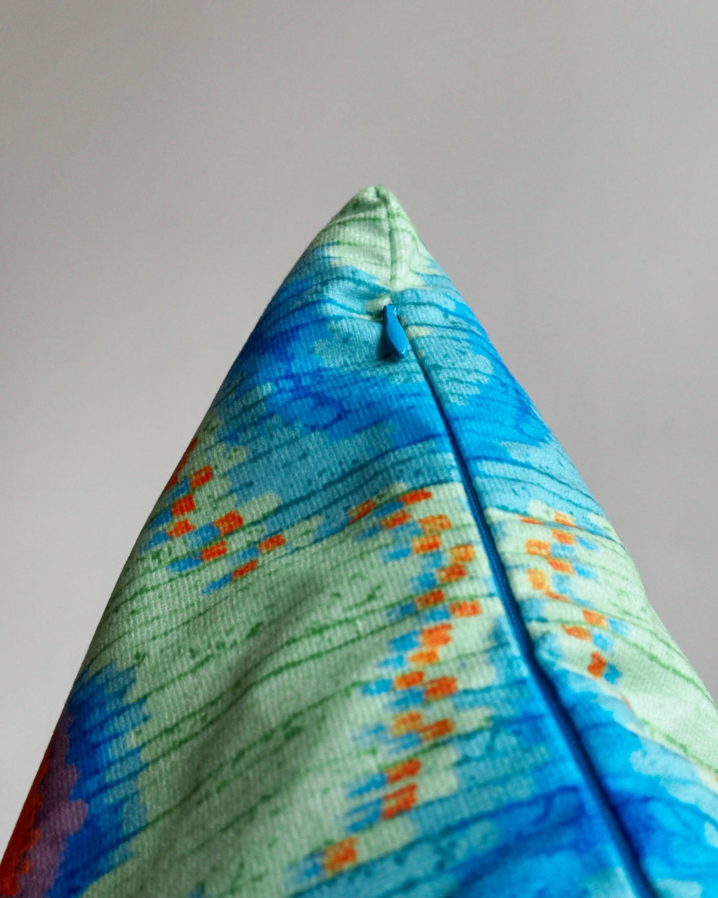 Close-up of hidden zipper closure in blue on green and klein blue abstract floral leopard cushion cover, showing easy insertion and premium construction details.