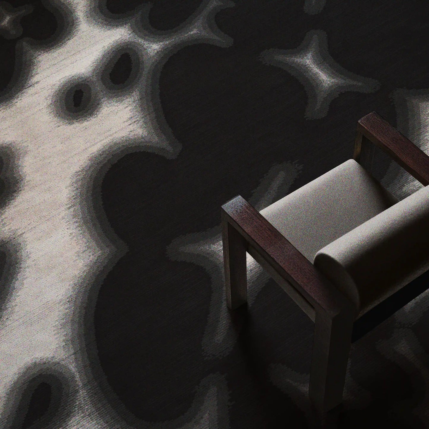 A large 9x12 ft black and off-white floral cowhide area rug placed underneath a light grey wooden air chair, a dopamine home decor item for an eclectic aesthetic mid century modern apartment.