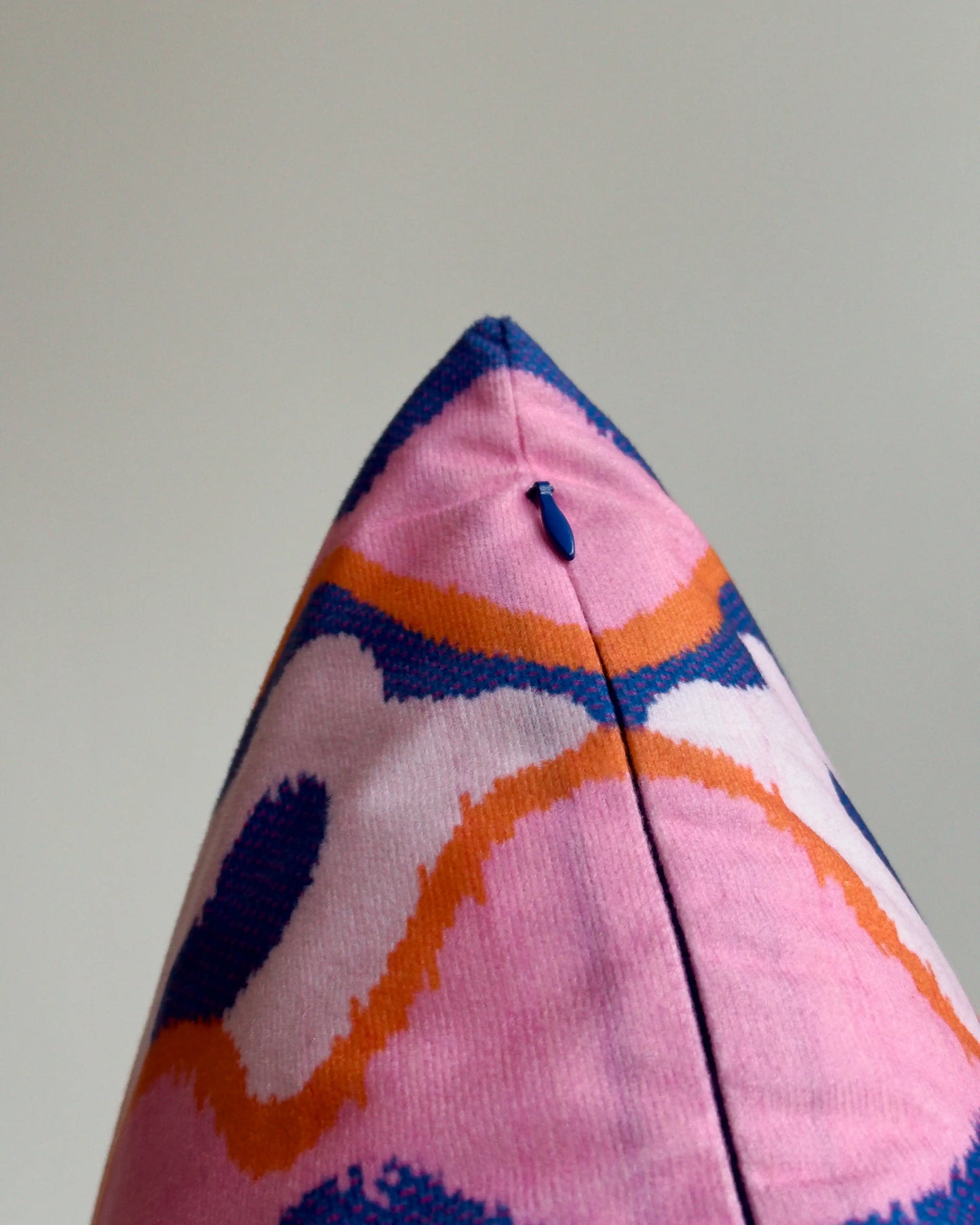 Close-up of hidden zipper closure in blue on Klein blue and pink abstract floral cushion cover, showing easy insertion and premium construction details.