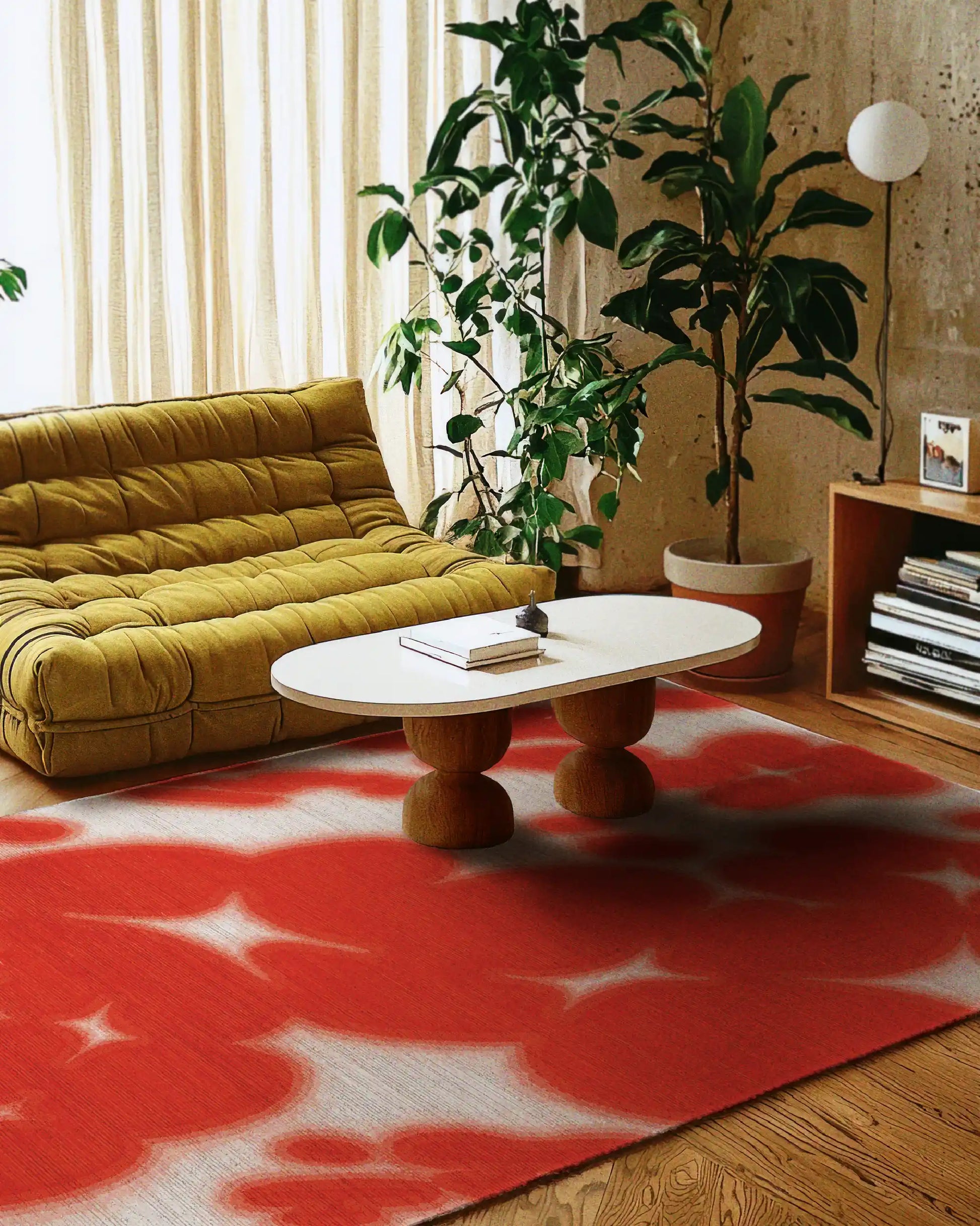 Man stands on an eclectic home decor, the dopamine colorful red and off white floral cowhide aura area rug, with abstract resembling cowhide animal print printed on a faux wool, low pile area rug, size 8x10 ft.