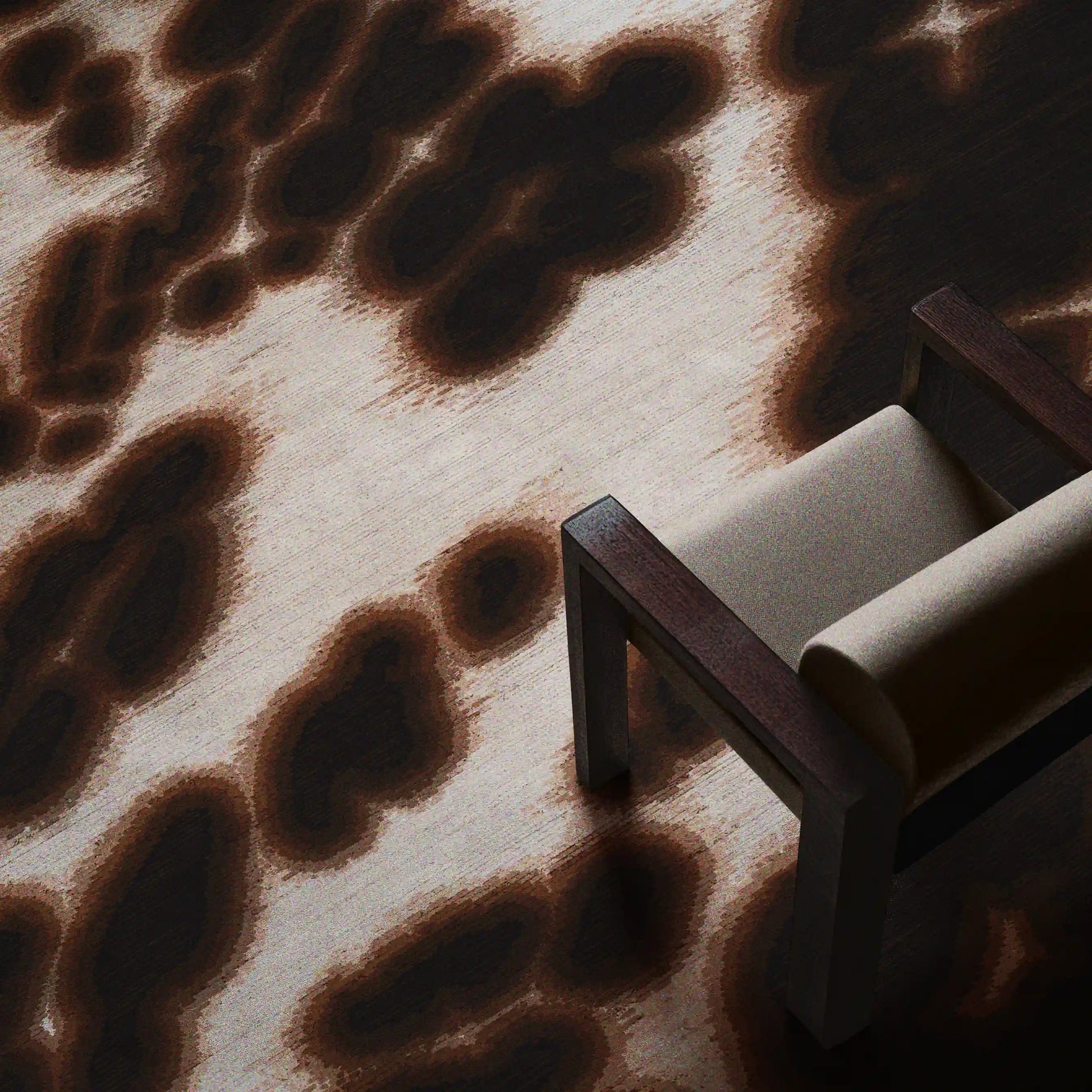 Floral cowhide rug in dark brown and off white aura area rug placed underneath a light grey wood armchair in the living room.
