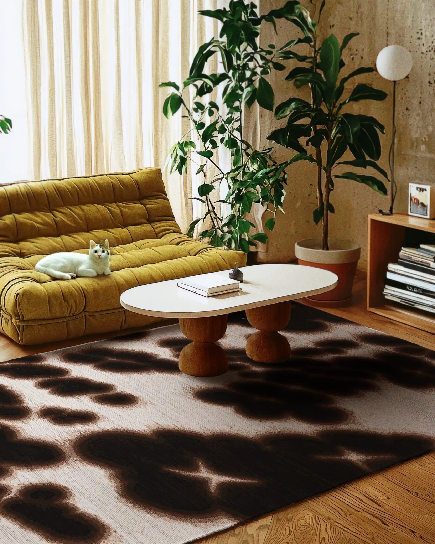 Floral cowhide area rug in dark brown and off white hues placed in a cozy living room, underneath a wood based coffee table, with a white cat relaxing on a yellow togo sofa, a wooden book cabinet, and a large house plant in mid century modern style.