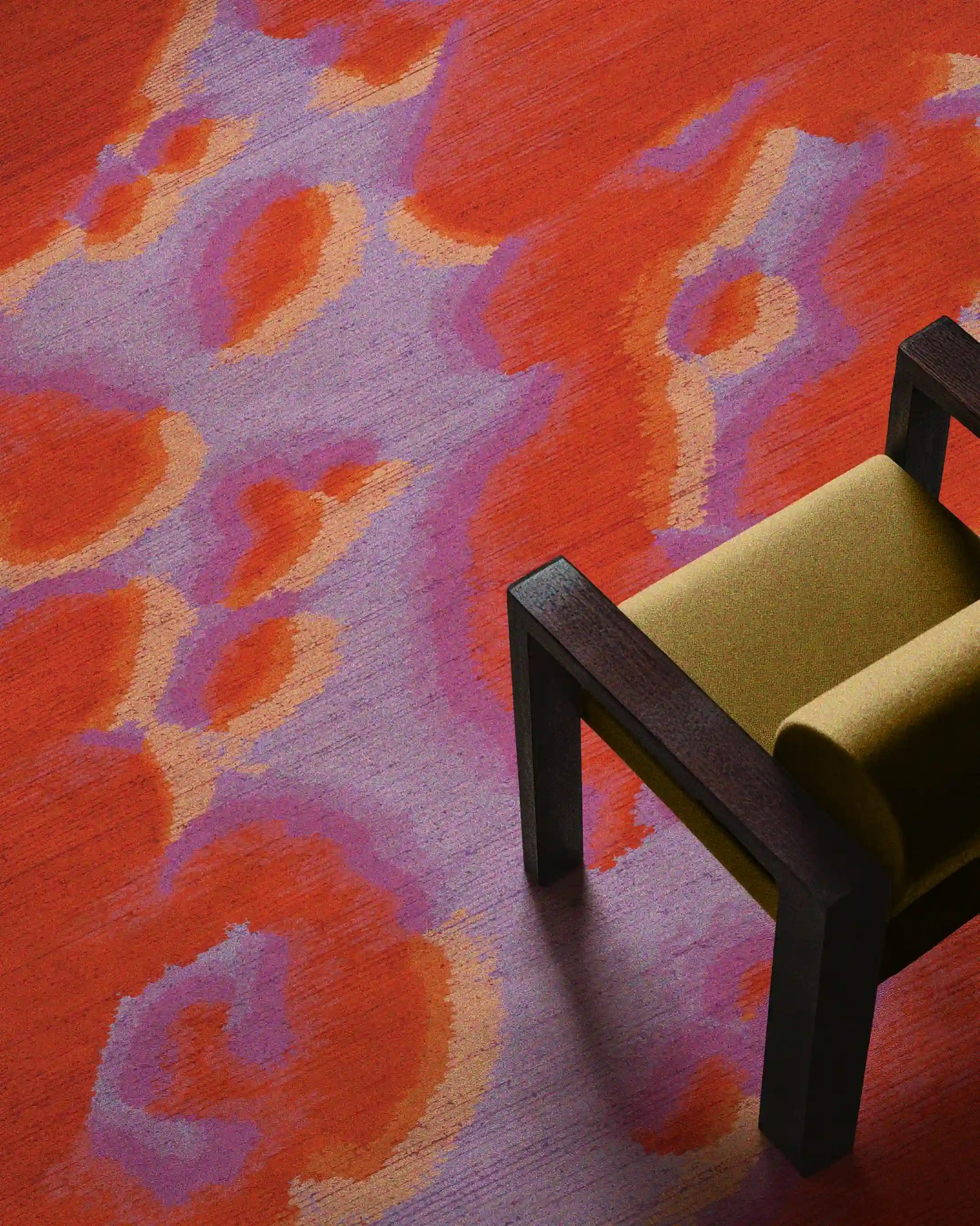 Fall eclectic red and pastel purple abstract camouflage area rug placed underneath a yellow wood armchair in the modern apartment. Dopamine home decor for maximalist home.