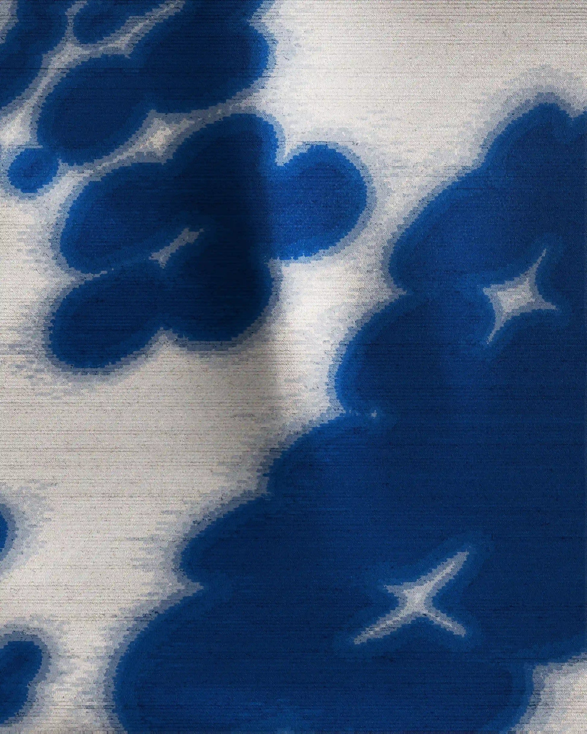 This versatile Klein blue and off white mulberry silk scarf is neatly folded on a beige background, showcasing its precise edge binding and elegant structure, perfect for use as a sophisticated colorful  waist scarf, dopamine bandana, handkerchief, eclectic twilly, or table placemat.