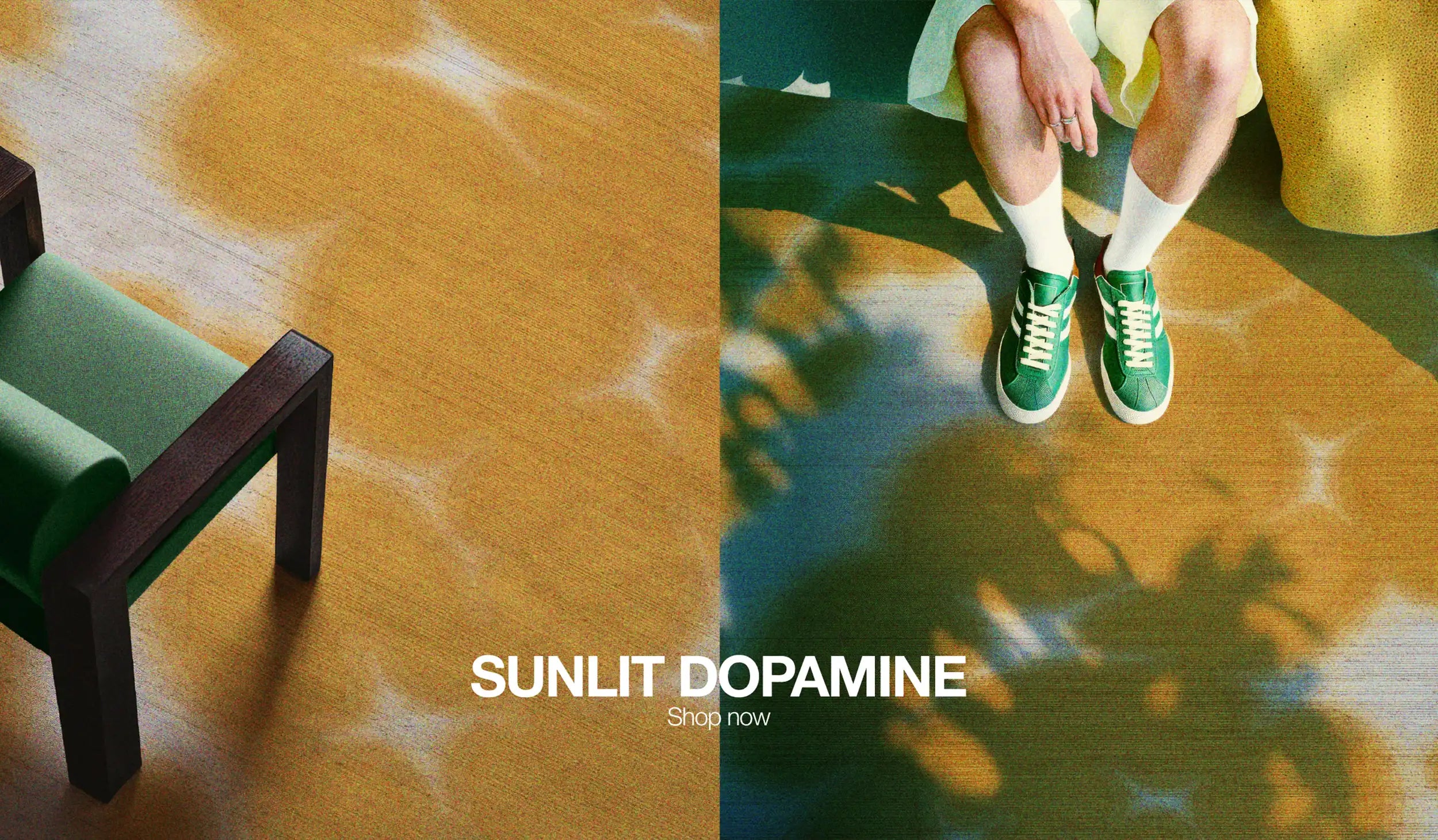 Desktop hero image for website of a green wooden armchair placed on top of a floral cowhide area rug on the right image, and a man is resting on the same carpet, wearing a trendy outfit, light yellow shorts, white socks, and green sneakers.