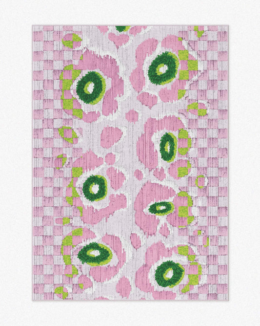 A pink and green floral checkered rug, 5x7 ft, with a resemblance to leopard floral patterns, set against a light beige background, highlighting its contemporary, playful, and eclectic aesthetic. Unique area rug for a maximalist and pink apartment.