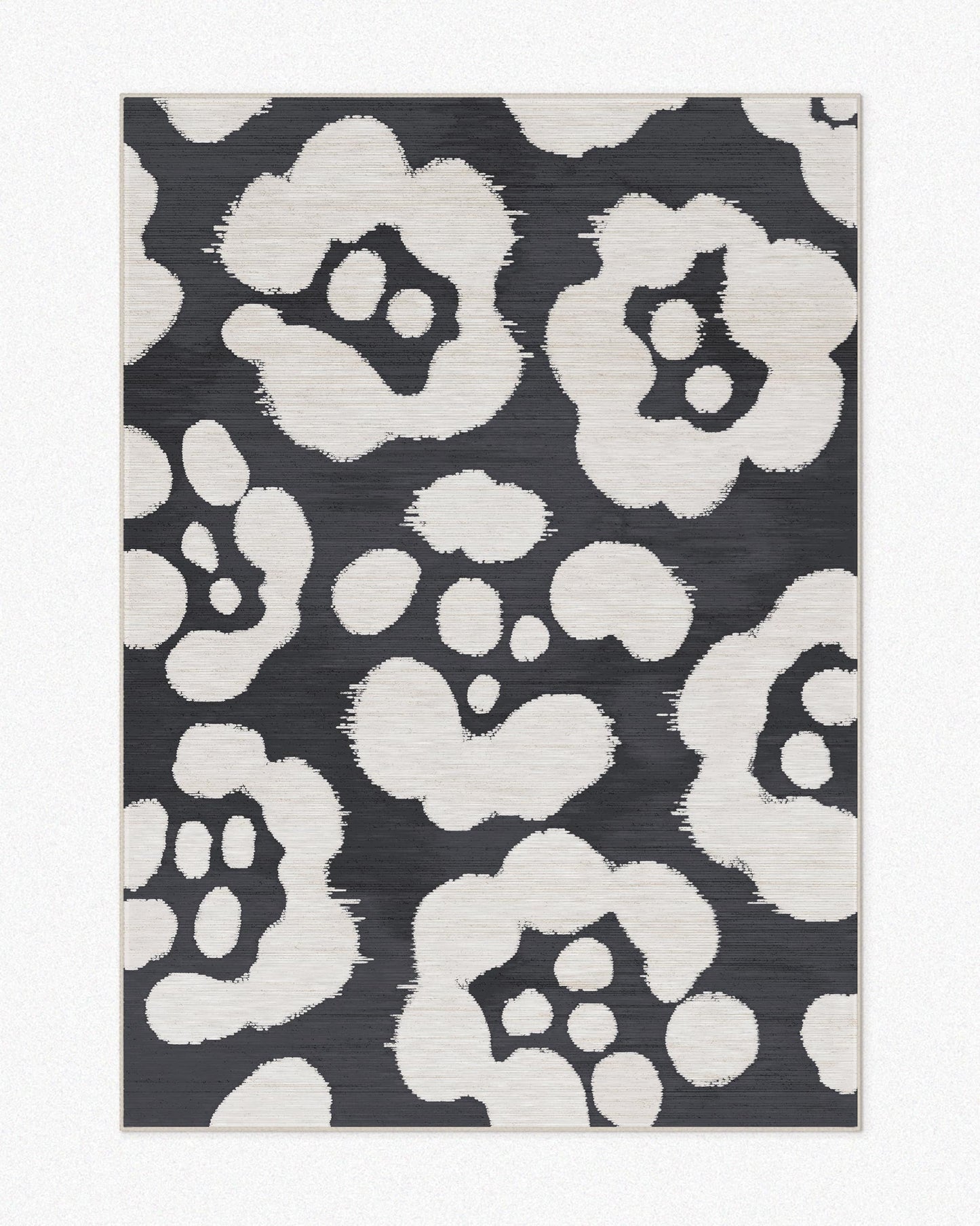 Floral area rug 5x7 with floral patterns and black and off white hues set against a light beige background, highlighting its mid century modern aesthetic.