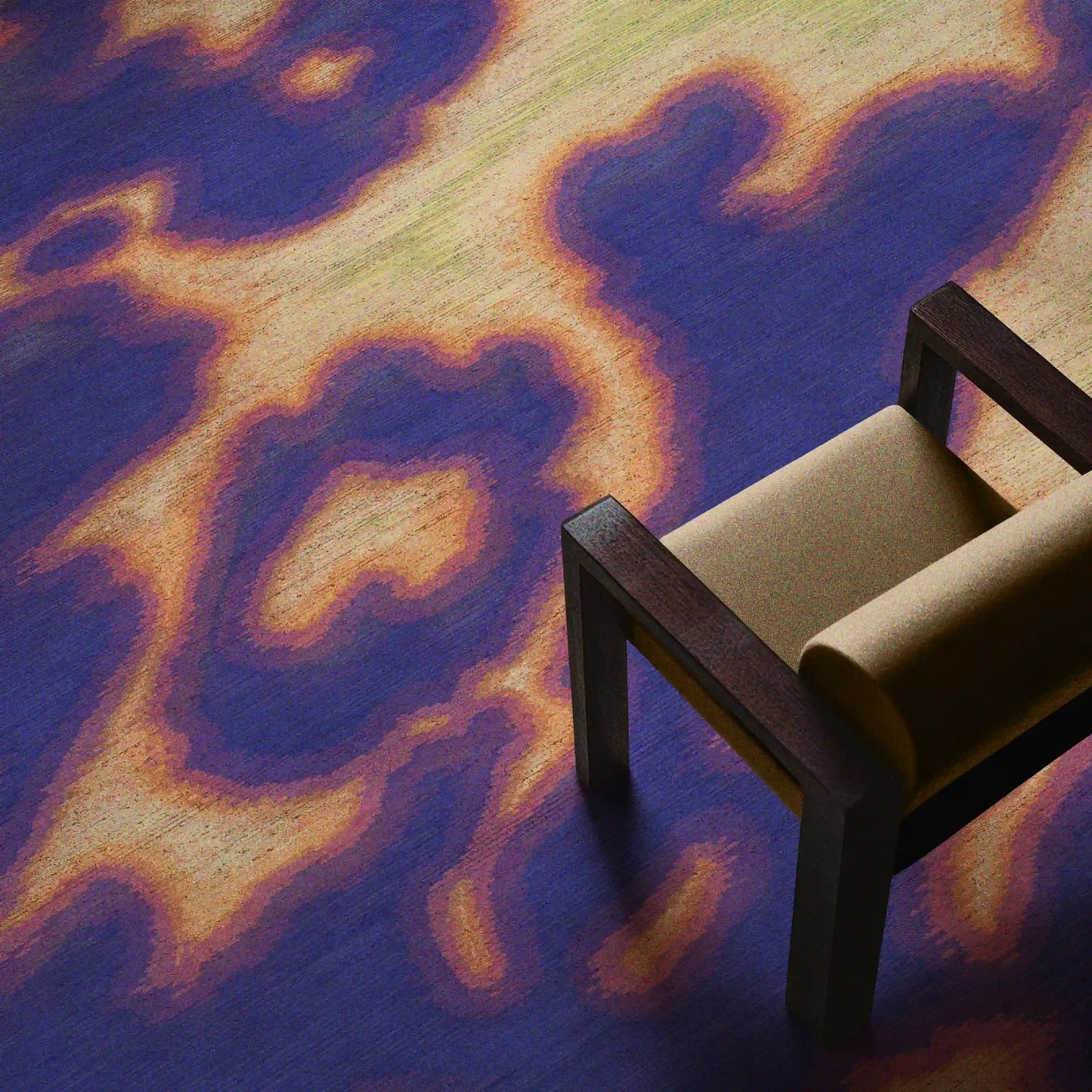 Floral cowhide rug in purplish blue and light green aura area rug placed underneath a yellow wood armchair in the living room.