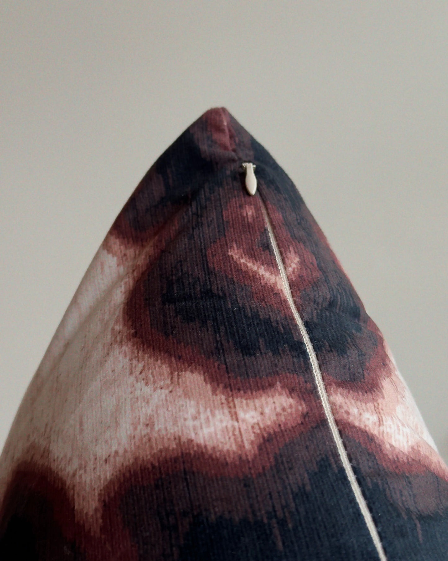 Close-up of hidden zipper closure in cream white on brown and off white abstract floral cowhide cushion cover, showing easy insertion and premium construction details.