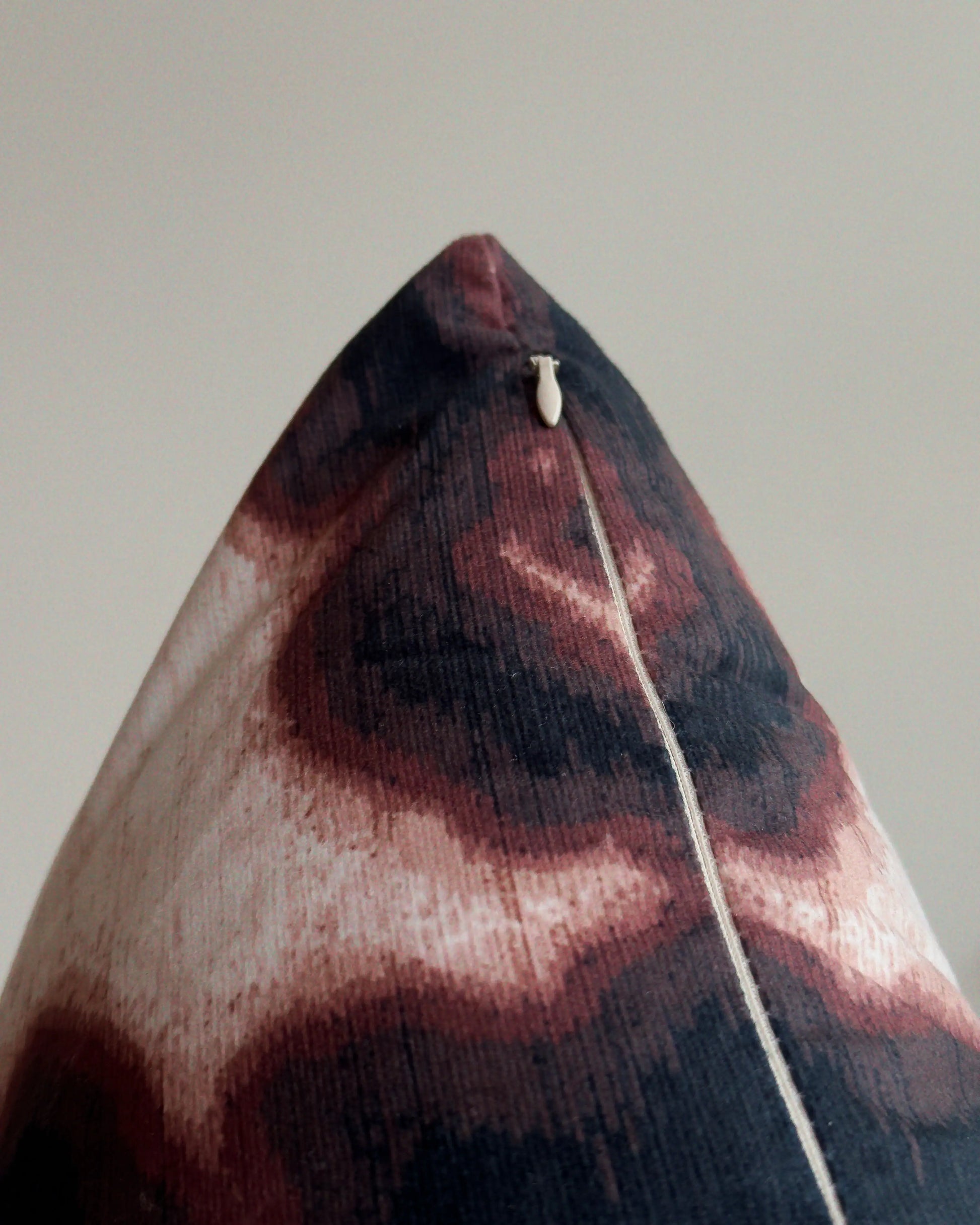 Close-up of hidden zipper closure in cream white on brown and off white abstract floral cowhide cushion cover, showing easy insertion and premium construction details.