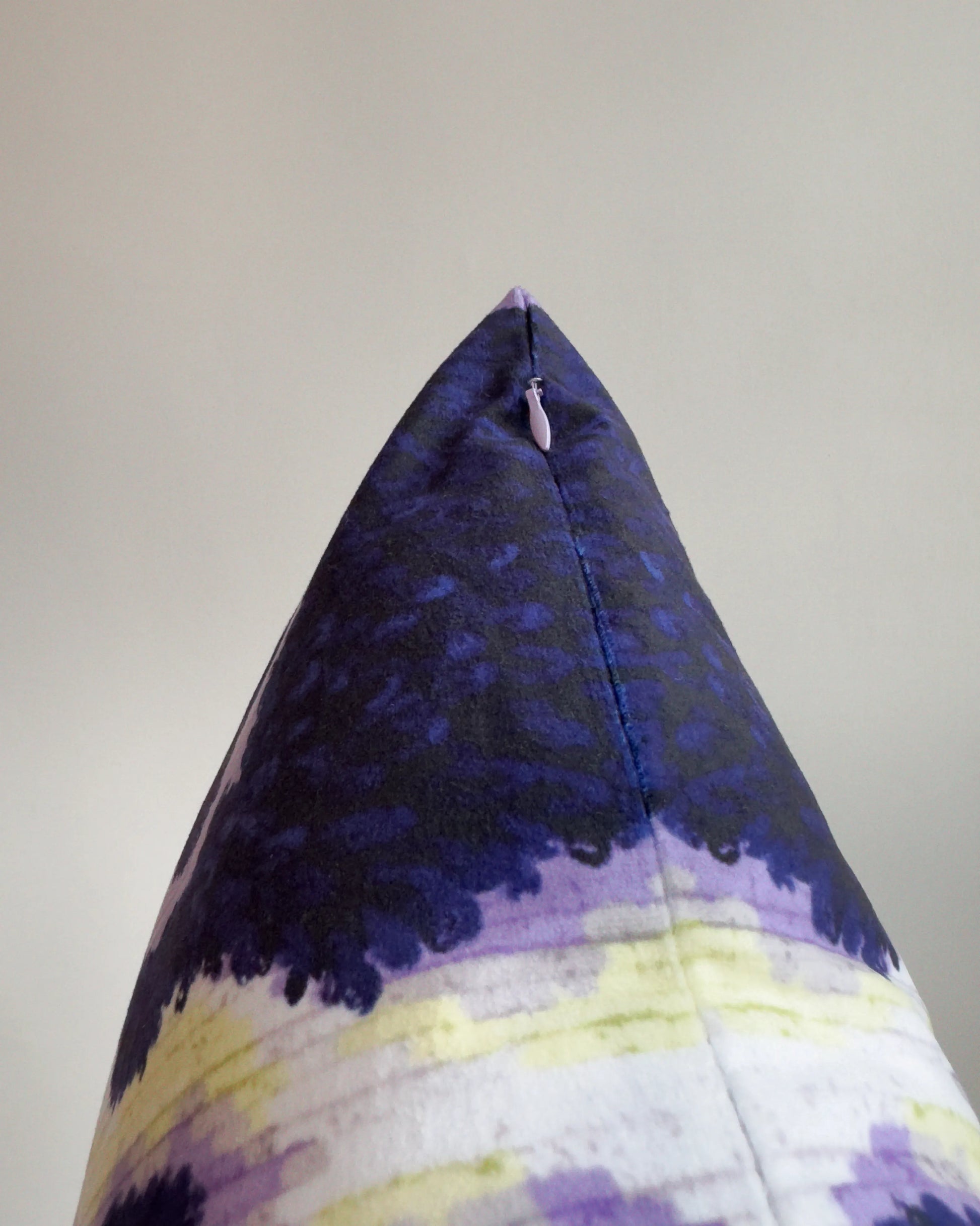 Close-up of hidden zipper closure in pastel purple on dark brown, pastel purple and off white abstract cowhide cushion cover, showing easy insertion and premium construction details.