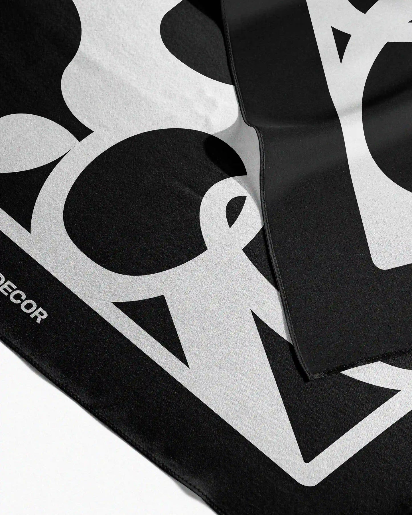 Neatly folded versatile 100% mulberry silk scarf, a 4-in-1 convertible accessory that can be a twilly, table placemat, waist scarf, or hair wrap bandana.