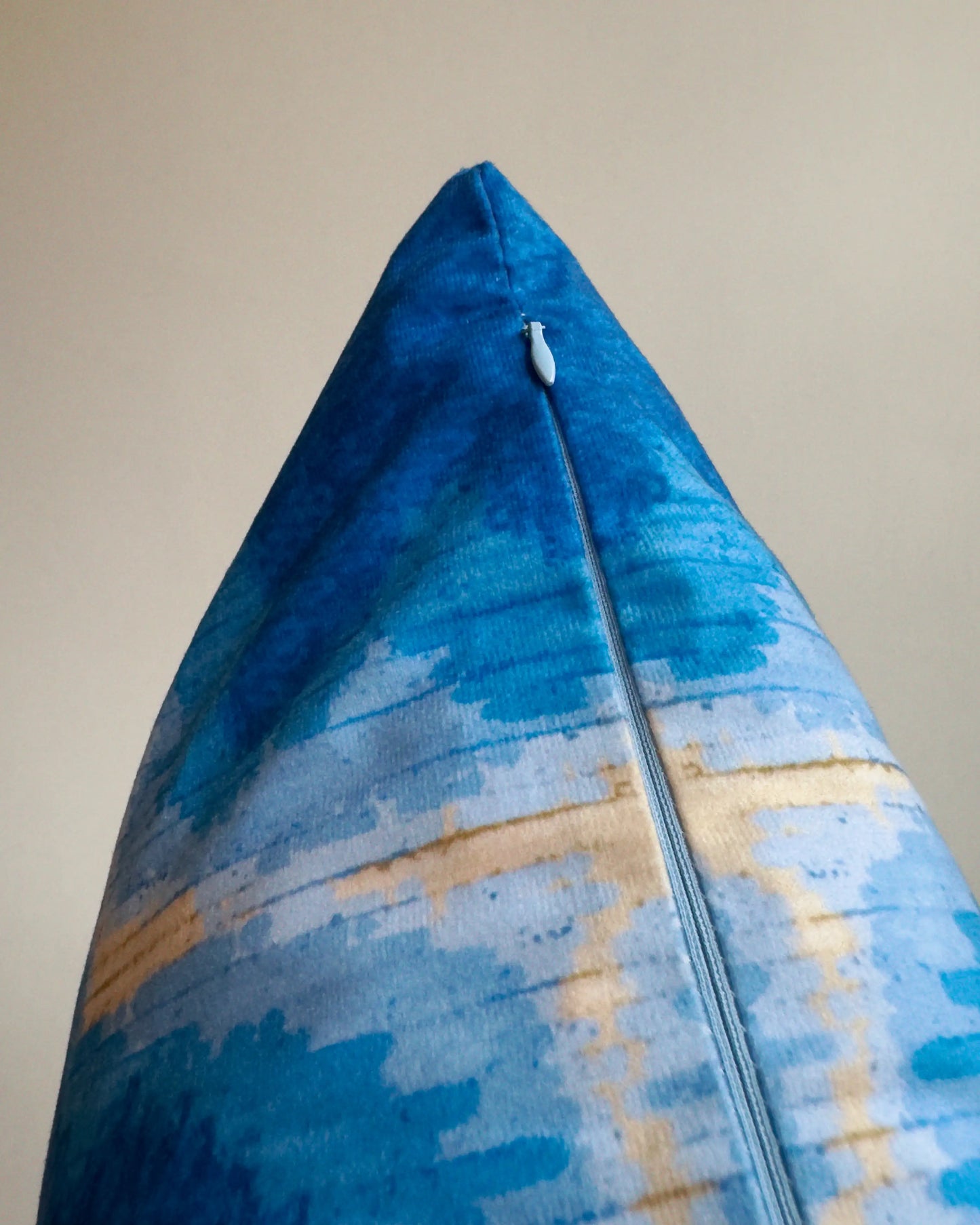 Close-up of hidden zipper closure in light blue on Klein blue and sand beige abstract handpainted tie dyed cushion cover, showing easy insertion and premium construction details.