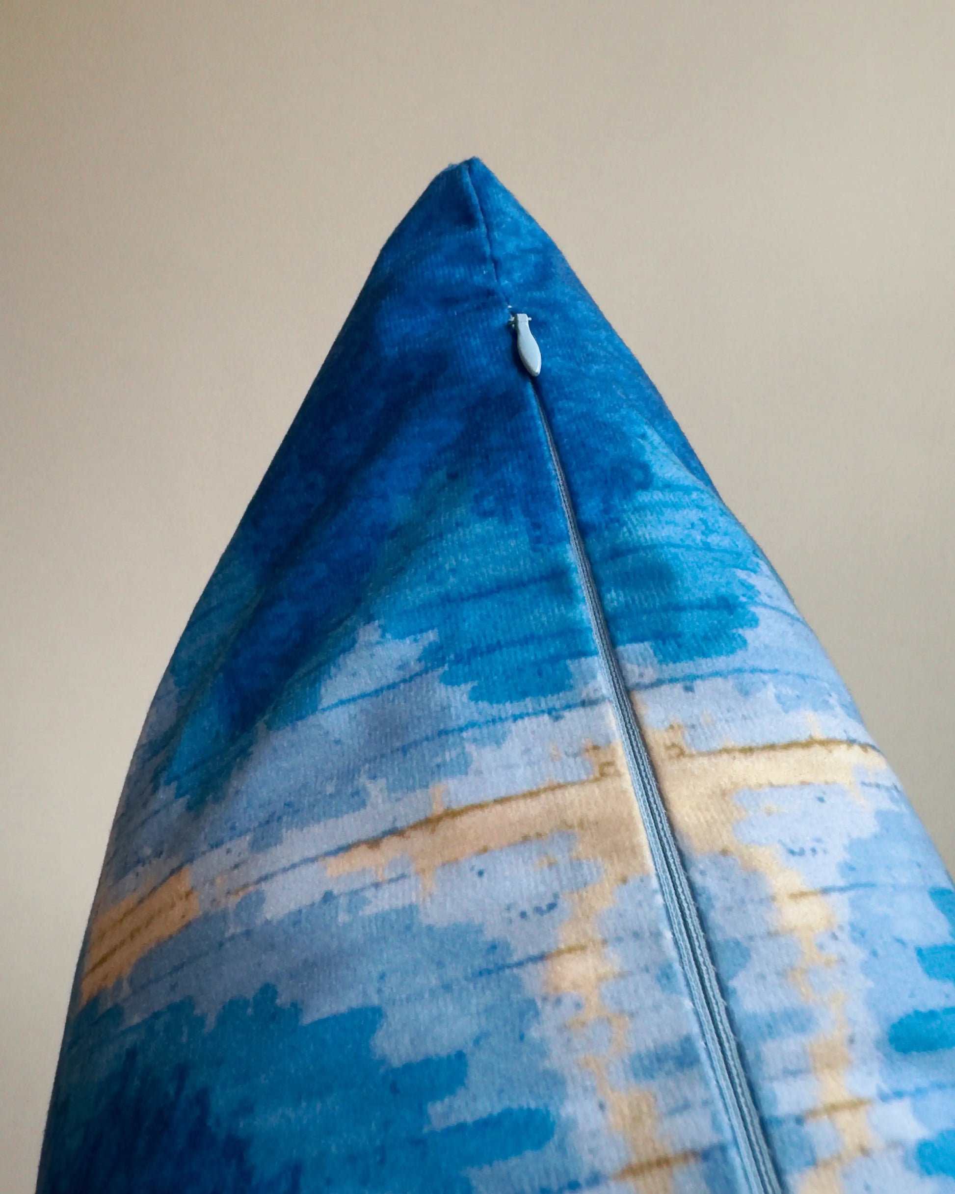 Close-up of hidden zipper closure in light blue on Klein blue and sand beige abstract handpainted tie dyed cushion cover, showing easy insertion and premium construction details.