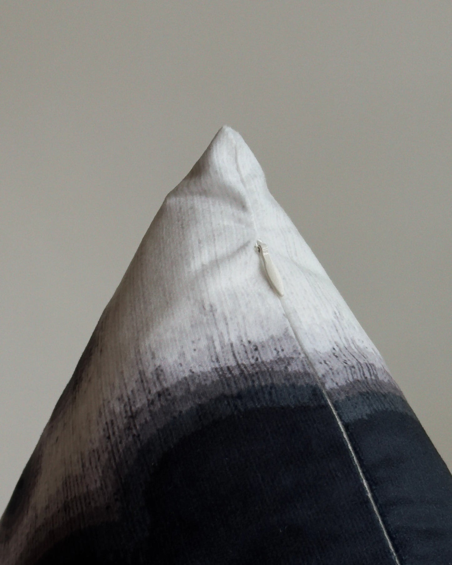 Close-up of hidden zipper closure in cream white on black and off white abstract floral cowhide cushion cover, showing easy insertion and premium construction details.