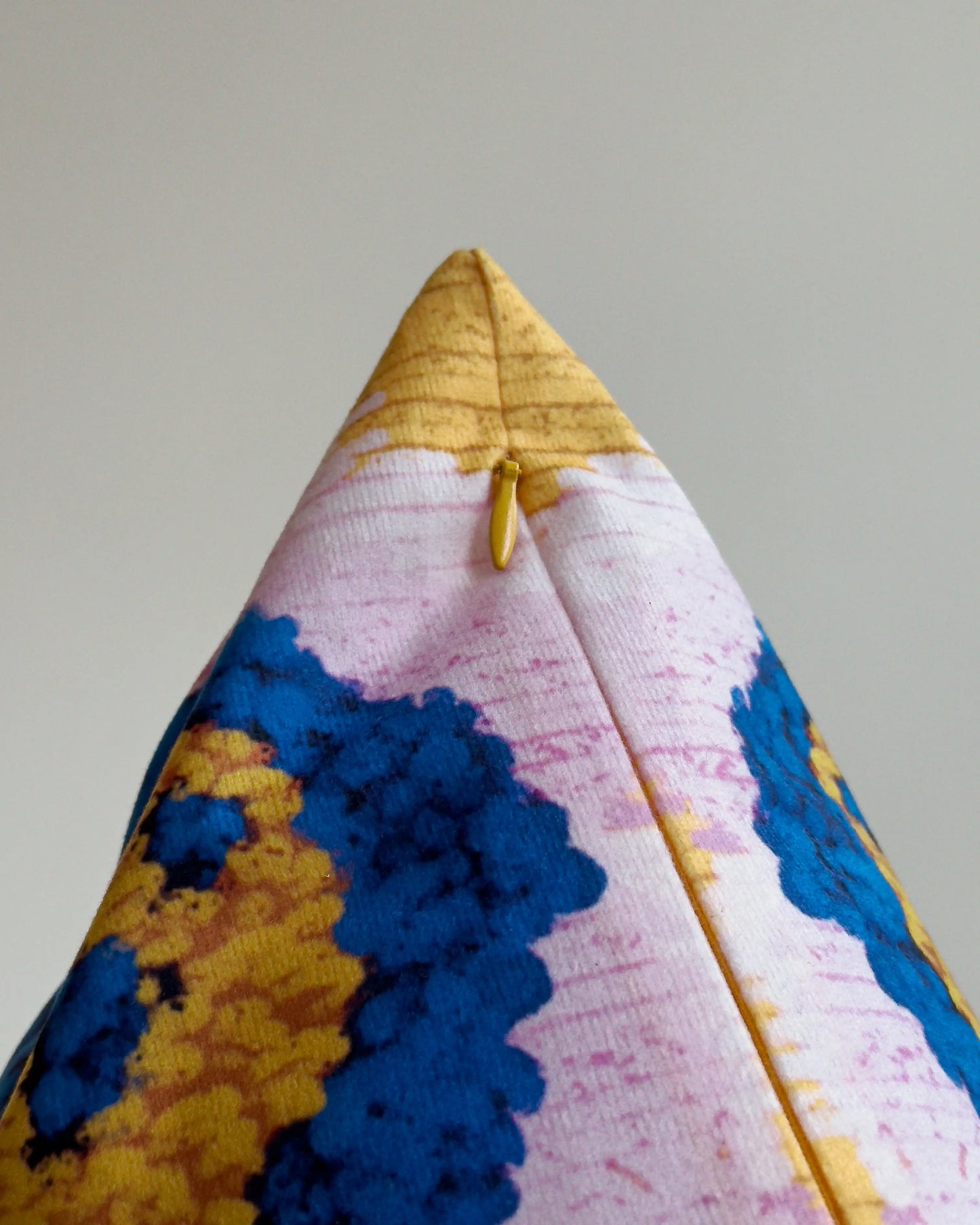 Close-up of hidden zipper closure in yellow on purple, mustard yellow and klein blue abstract floral leopard cushion cover, showing easy insertion and premium construction details.