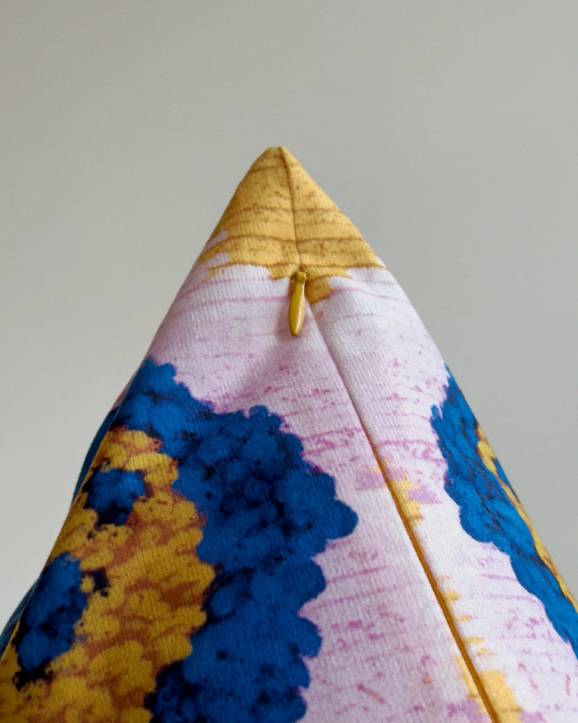 Close-up of hidden zipper closure in yellow on purple, mustard yellow and klein blue abstract floral leopard cushion cover, showing easy insertion and premium construction details.