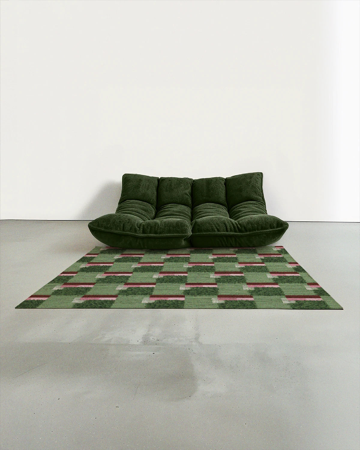 Sage green checkered area rug 5x7 placed in a mid century modern studio with a dark green Togo sofa.