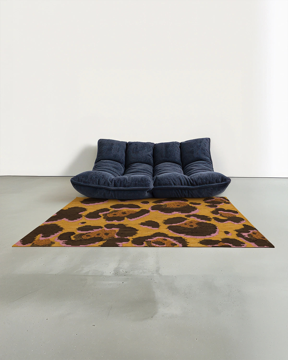 The eclectic home decor item, yellow leopard rug 5x7 placed in a modern studio with a navy Togo sofa.
