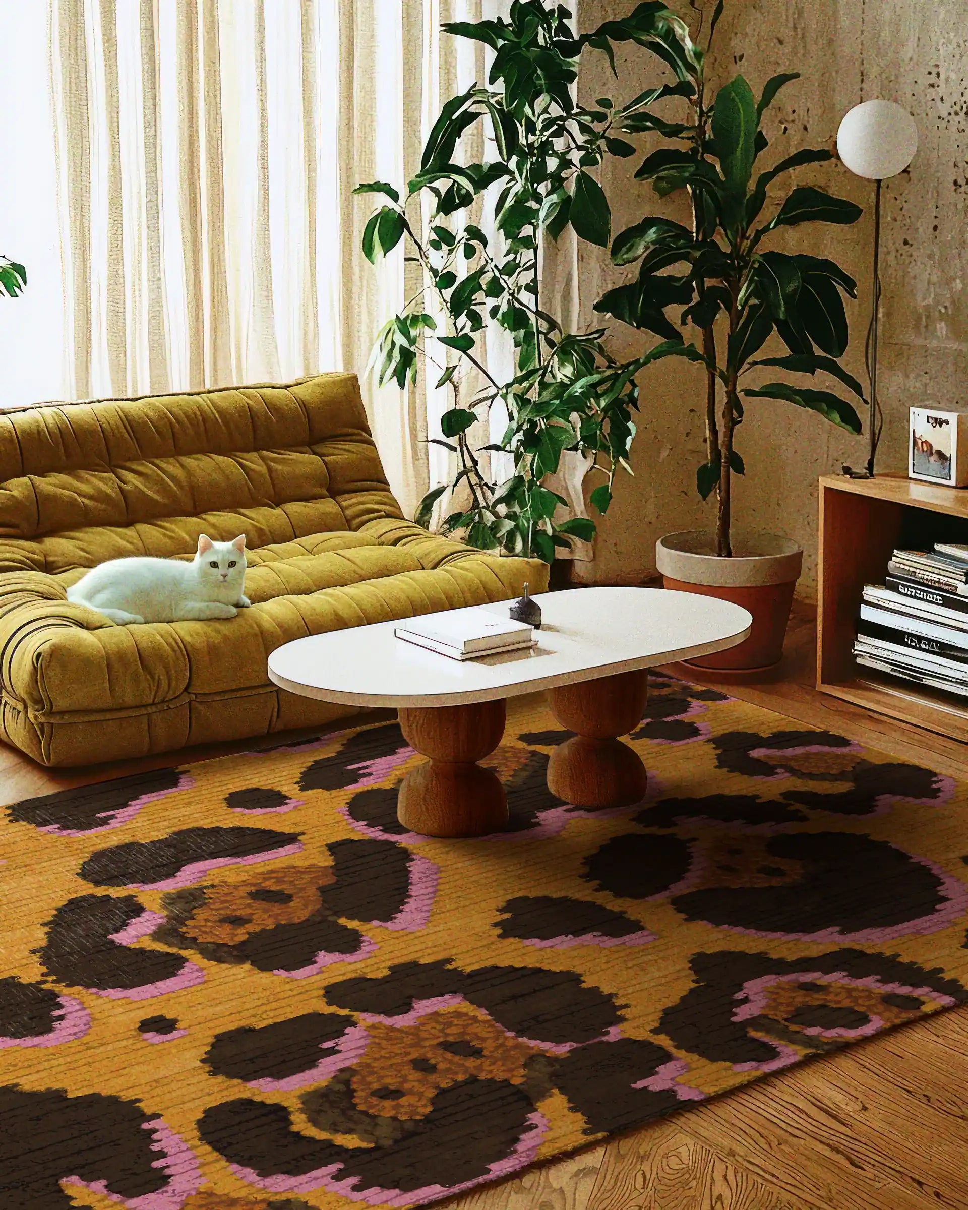 A yellow leopard rug is placed in a cozy living room featuring a wooden coffee table, a white cat, a yellow Togo sofa, and a large houseplant in the apartment.