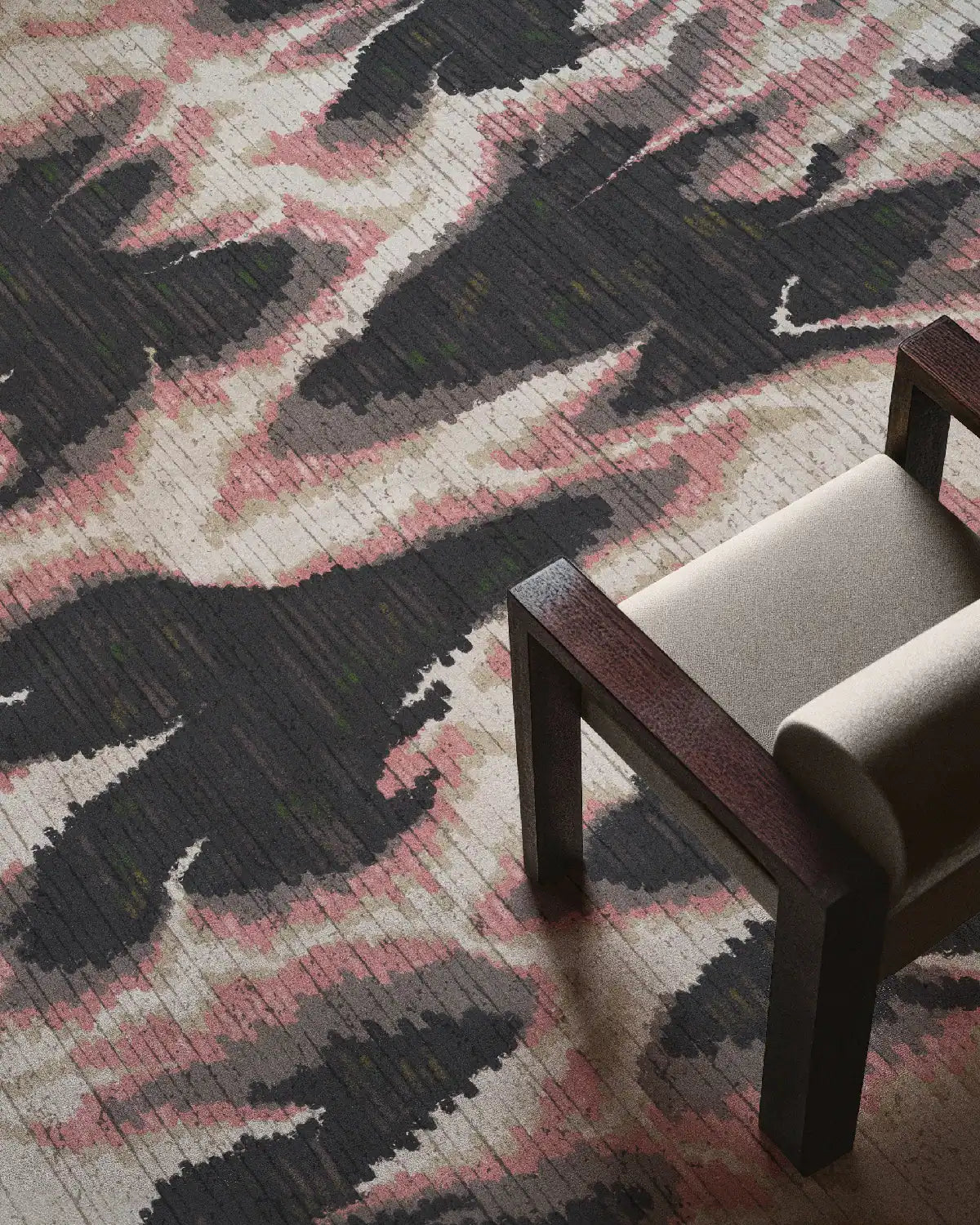 Maximalist home decor features a contemporary pink and grey area rug with aura patterns placed under a beige chair, enhancing the eclectic style interior design of the room.