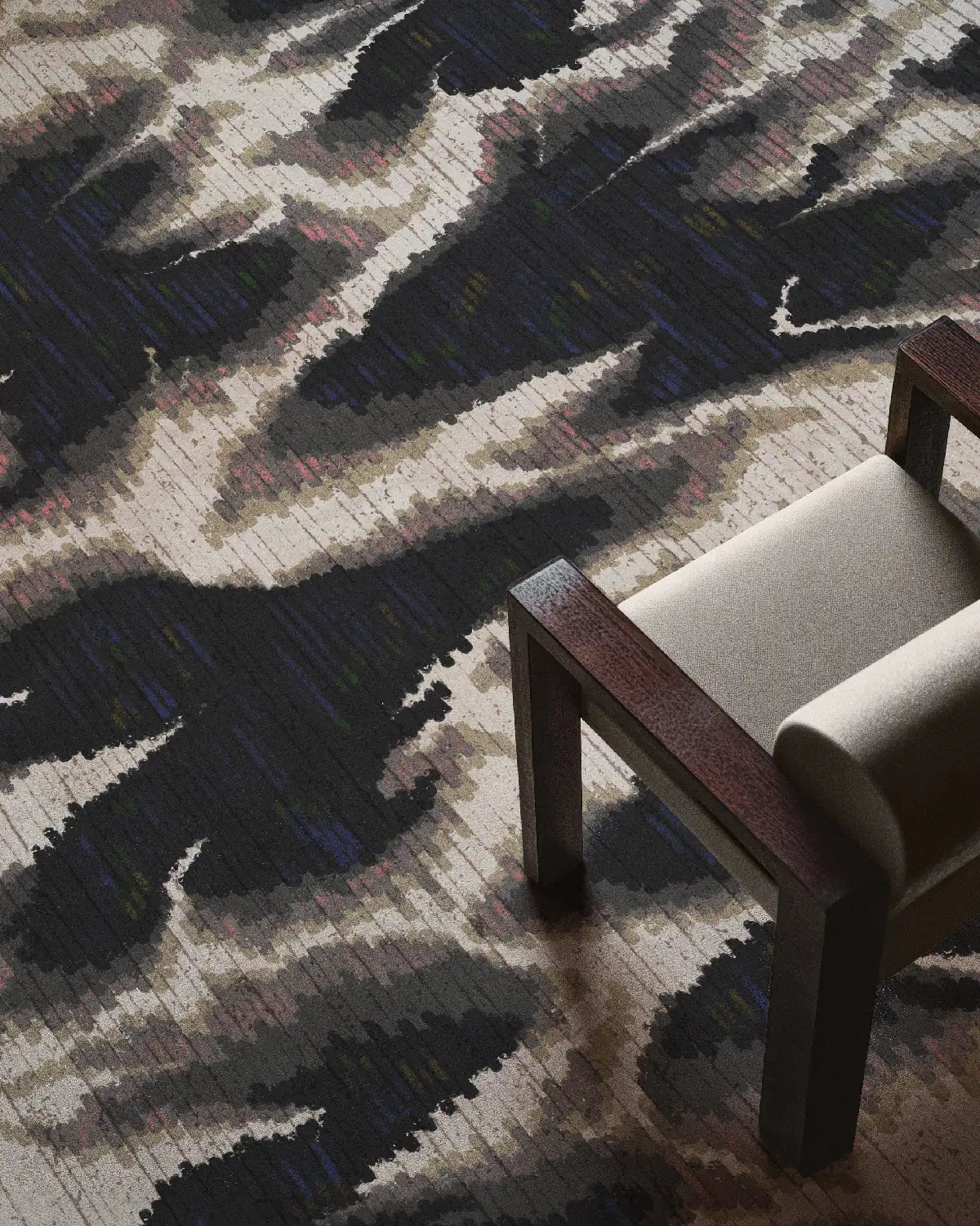 Scandinavian rug placed underneath beige chair featuring abstract aura design in grey, black and white hues in mid century modern living room.