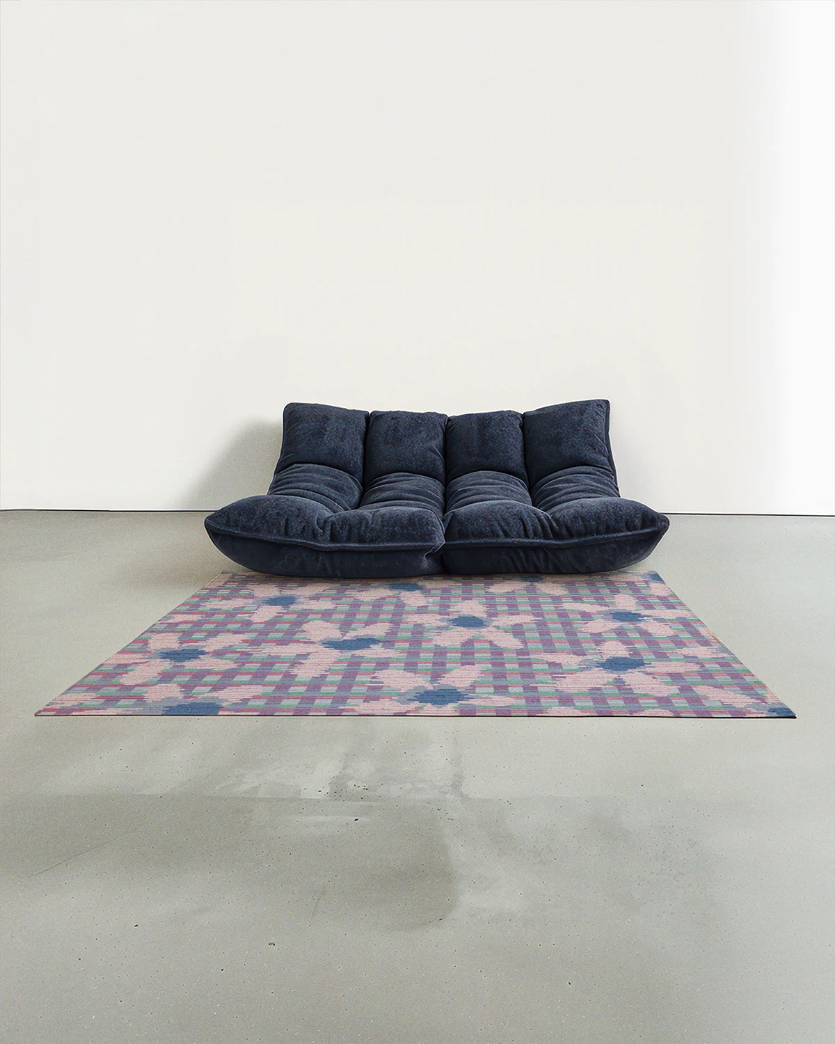 The dopamine decor, pastel purple floral checkered rug 5x7 placed in the modern studio with a navy Togo sofa.