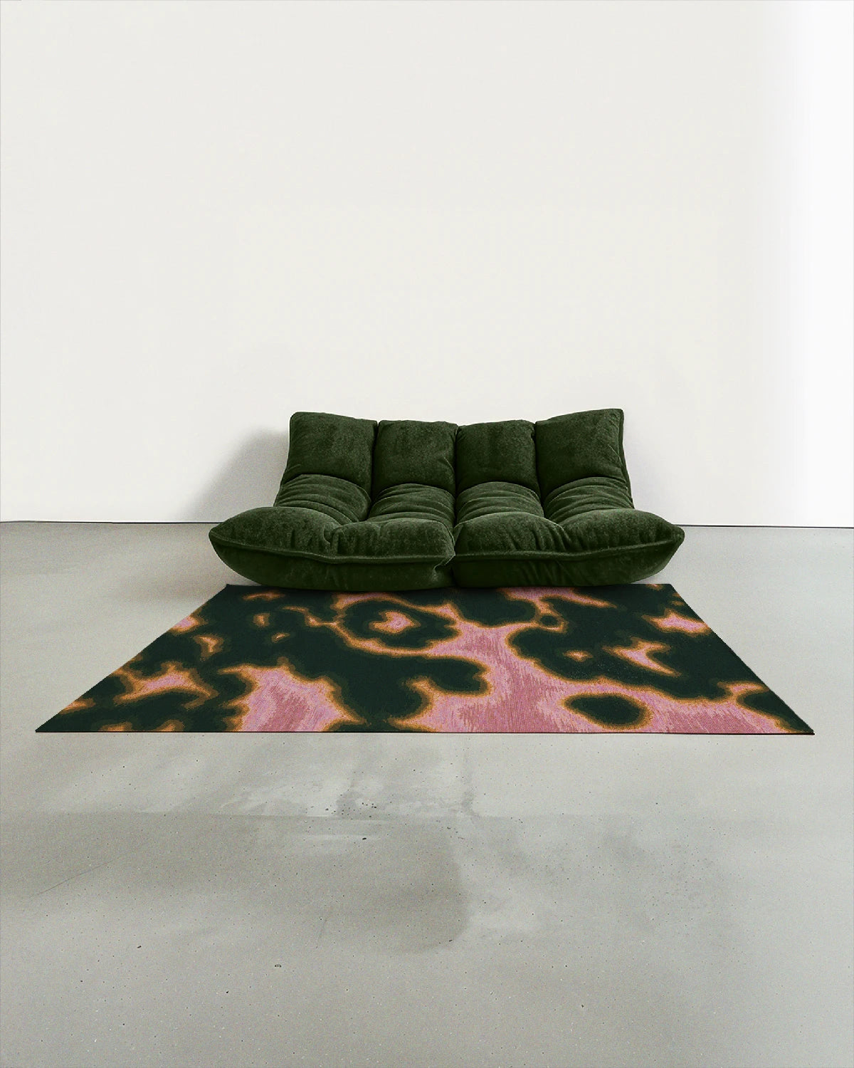 Aura area rug 5x7 ft, with a delicate cowhide floral pattern in dark forest green and pink, artfully placed in a contemporary studio with a dark green togo sofa.