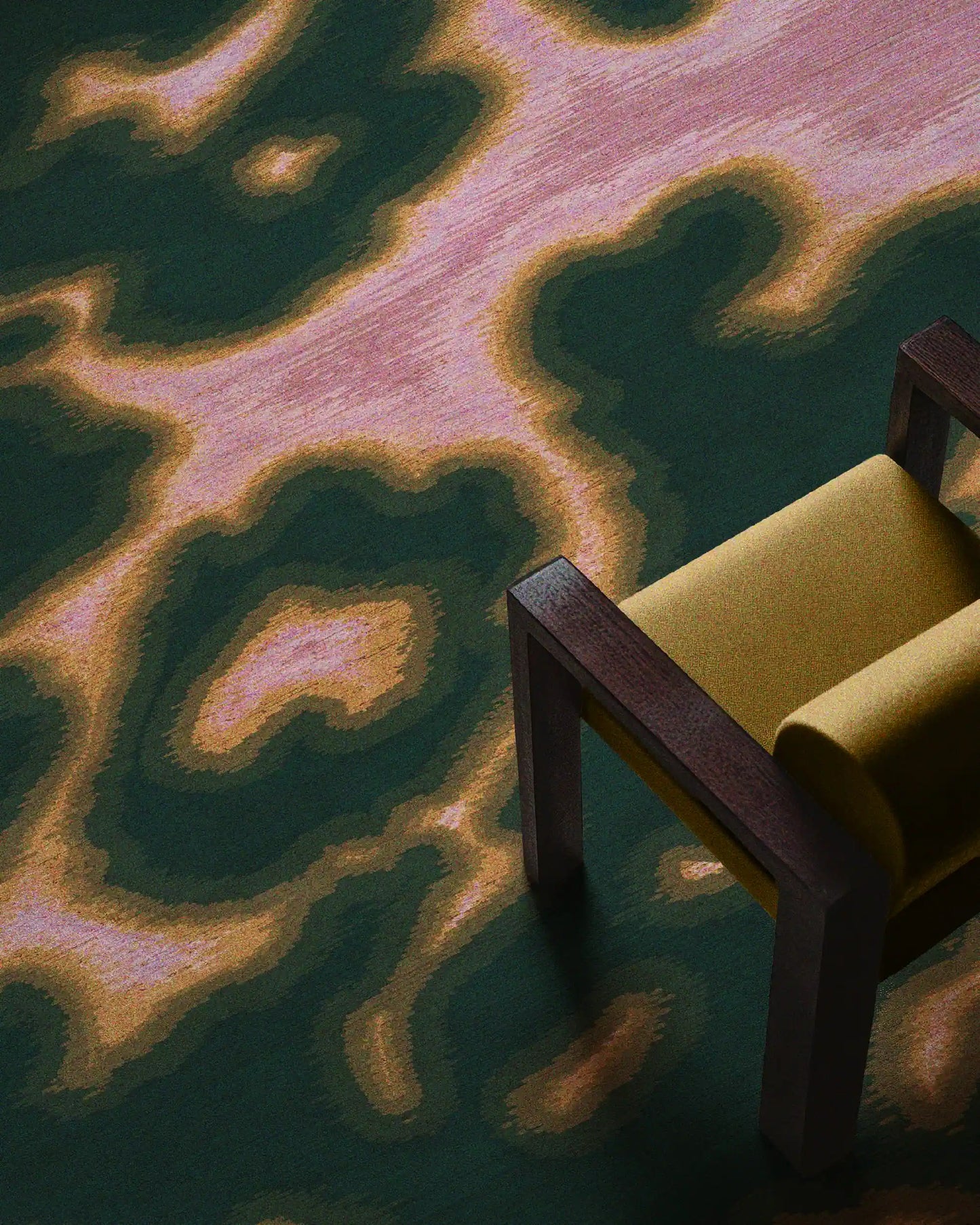 Floral cowhide rug in dark forest green and pink aura area rug placed underneath a yellow wood armchair in the living room.