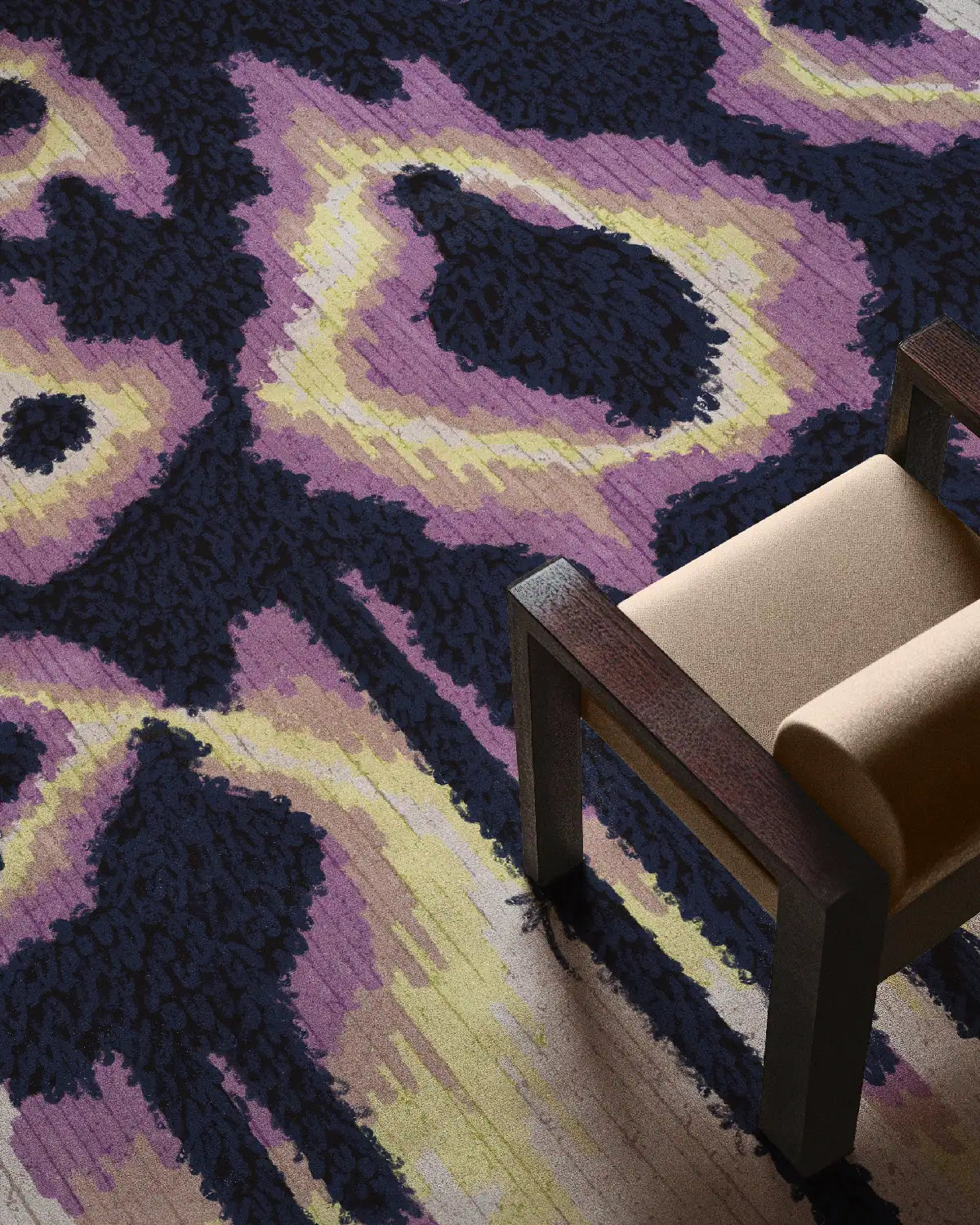 Animal print leopard rug 8x10 features purple and yellow hues underneath a cream beige chair, an eclectic home decor for a modern living room.
